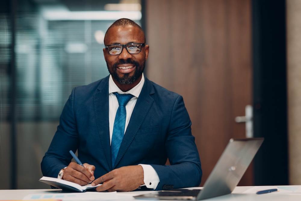 boss-smiling-african-american-businessman-sitting-2024-12-01-15-18-18-utc